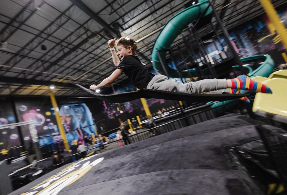 A child flying off a slide
