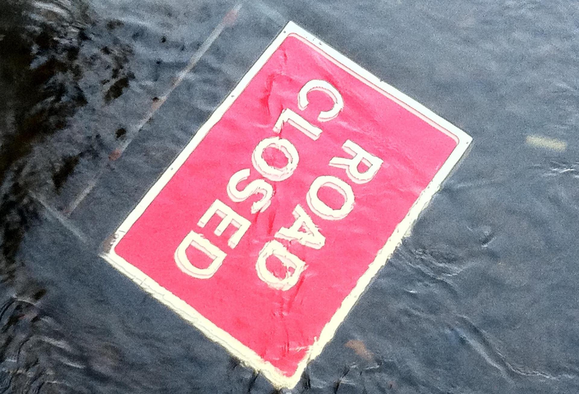 Road closed sign underwater