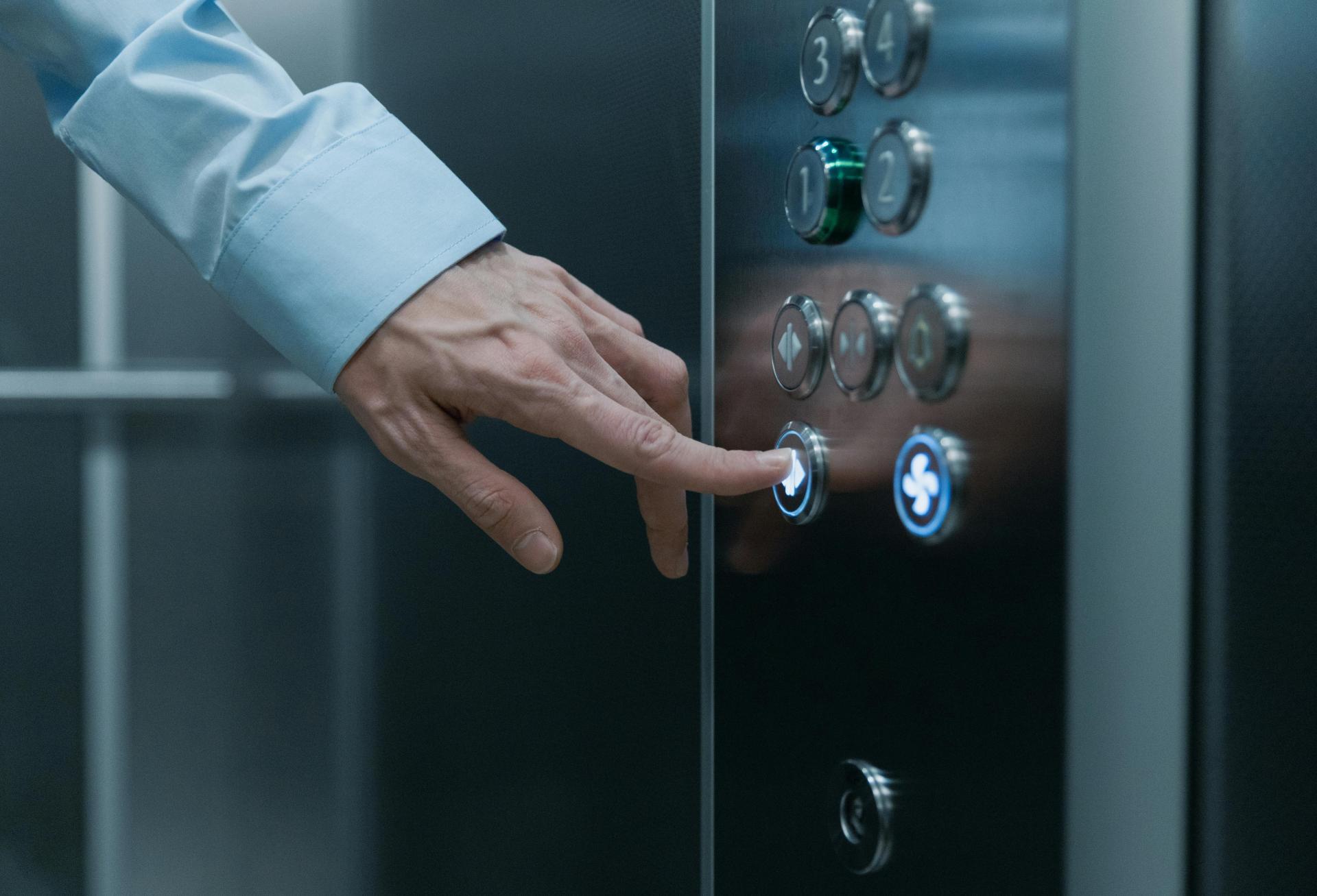 Man pushing elevator button