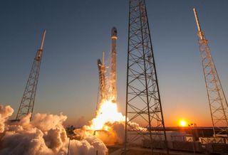 A powerful rocket launching into the twilight sky.