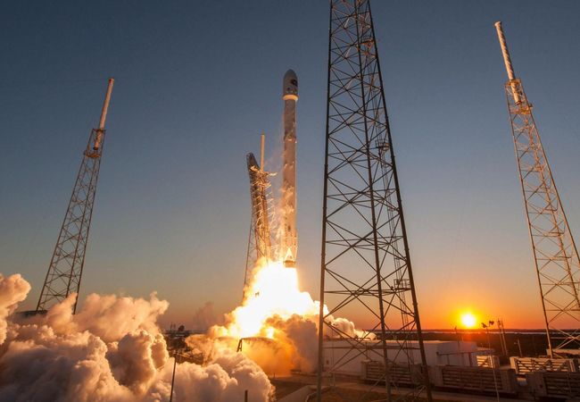 A powerful rocket launching into the twilight sky.