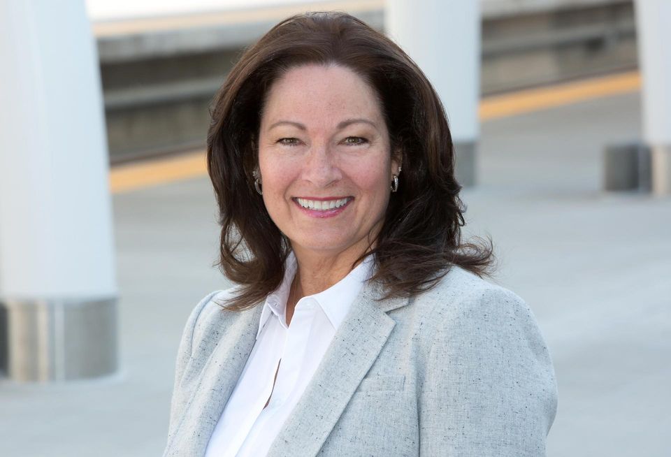 A professional portrait of NAIOP's executive director, Kathie Barstnar wearing a gray blazer