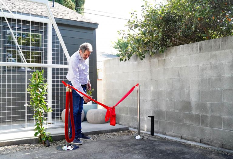 United Dwelling CEO Steven Dietz cuts the ceremonial ribbon at a resident's ADU in Los Angeles