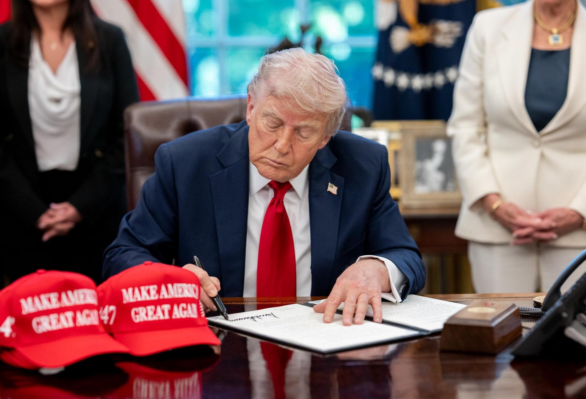 President Donald Trump signs executive orders alongside Secretary of Education Linda McMahon and wounded warriors in the Oval Office, Wednesday, April 23, 2025.