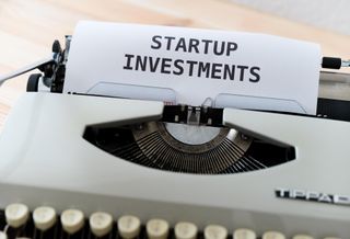 a typewriter showing the words "startup investments' 