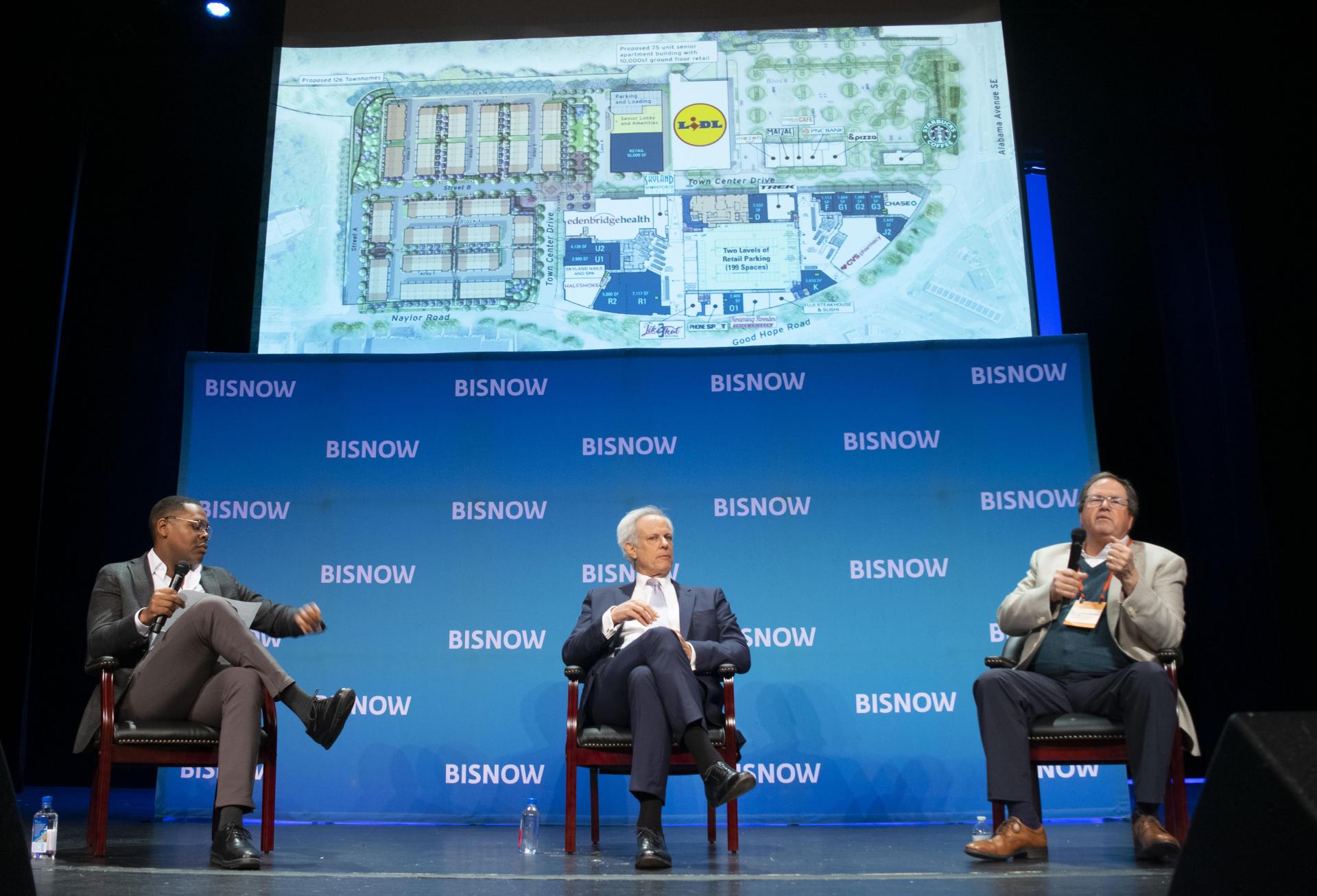 WC Smith Chairman and CEO Chris Smith shares plans for the final phase of Skyland Town Center, which include 126 townhomes and a 75-unit senior affordable housing community, during a panel with Rappaport Cos.' Gary Rappaport at Bisnow's Future of Wards 7 and 8 event on Dec. 13, 2022.