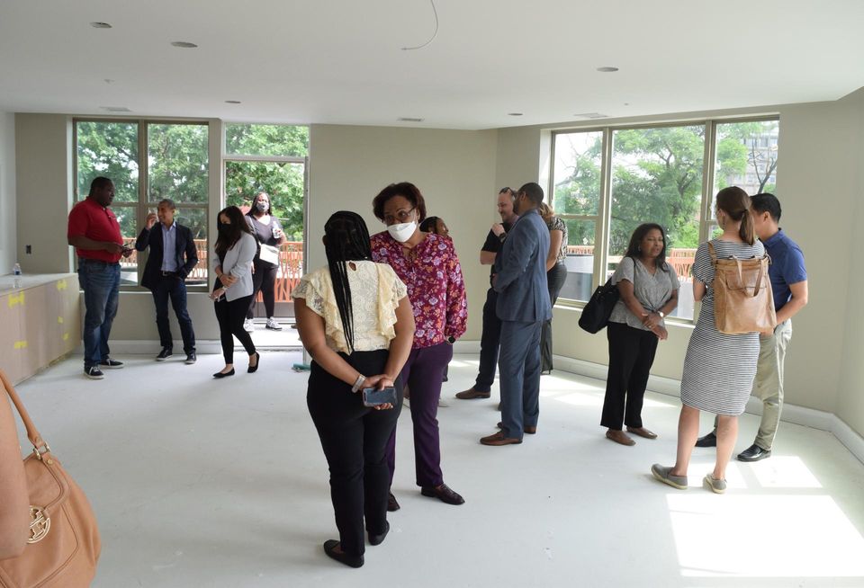 District officials and members of the development team tour the upstairs event room and balcony at Entwine.