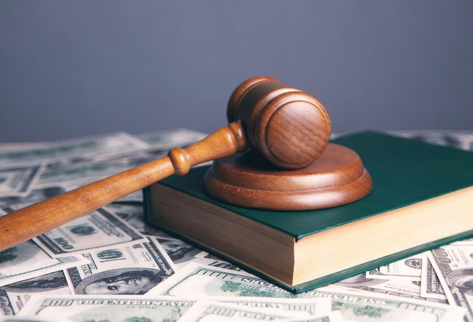 Gavel laying on top of money.