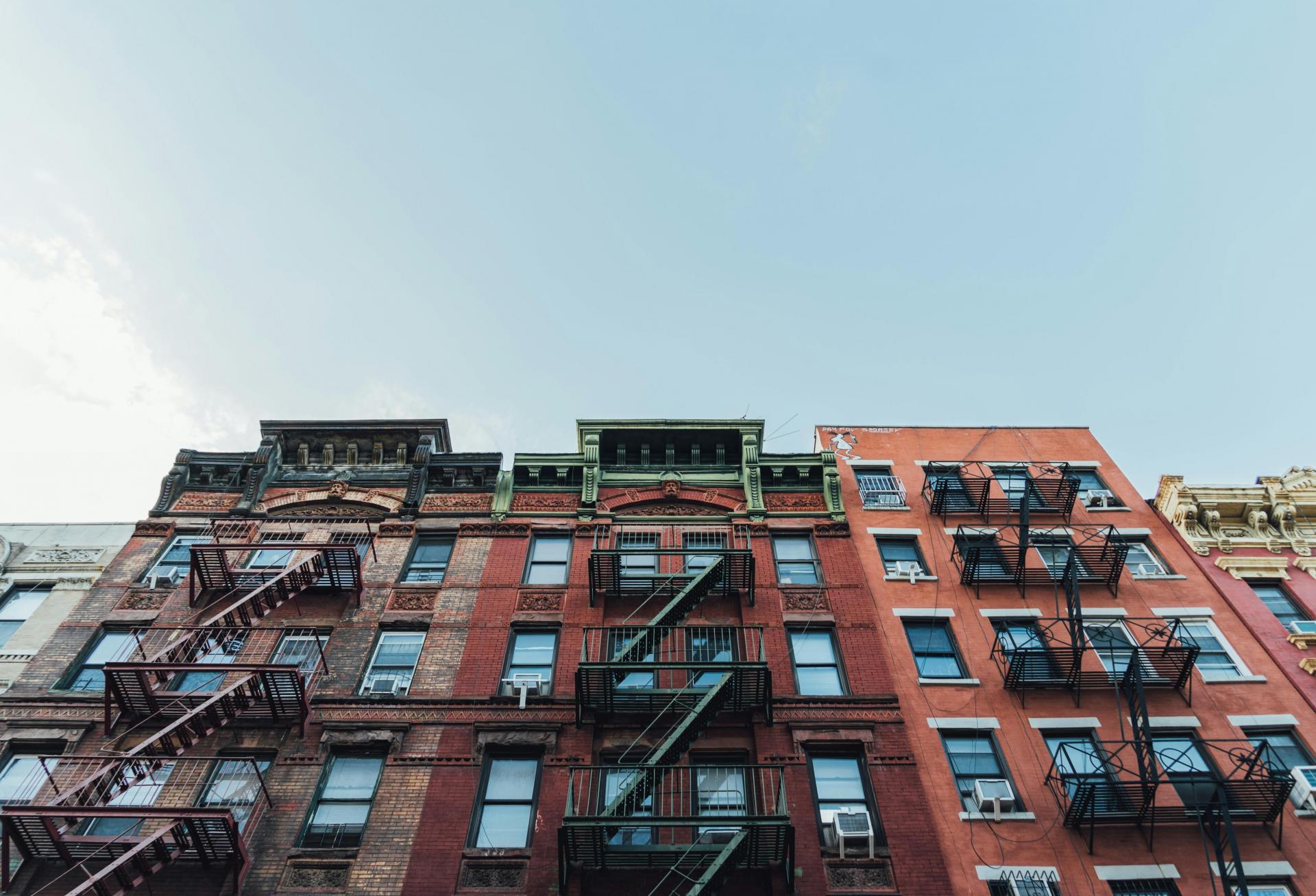 Apartment building exterior with blue sky in the background.