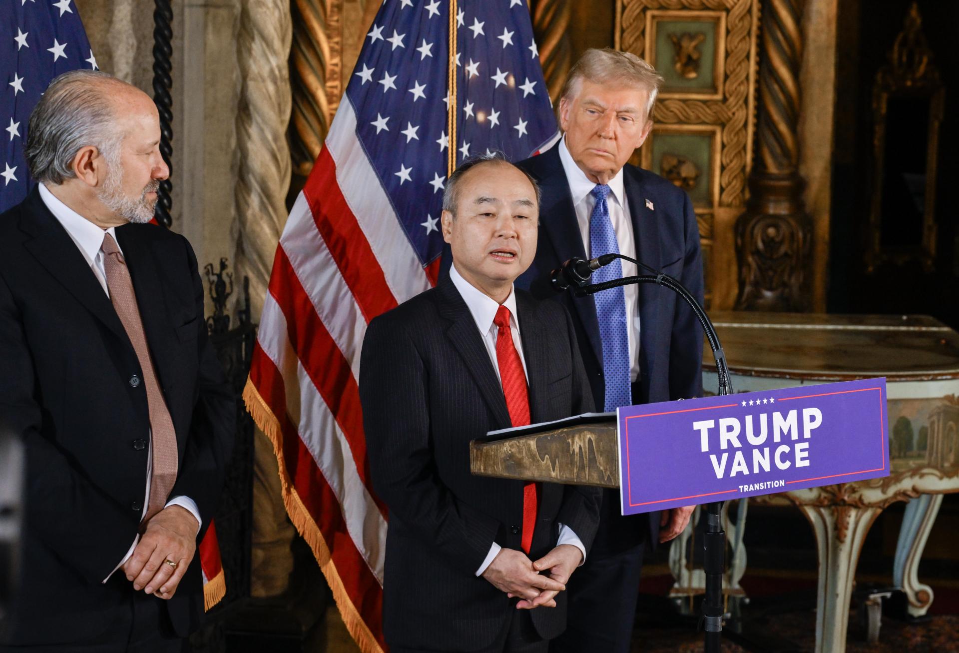 SoftBank founder Masayoshi Son announcing a planned $100B investment in U.S. technology at Mar-a-Lago with Commerce Secretary nominee Howard Lutnick and President-elect Donald Trump.