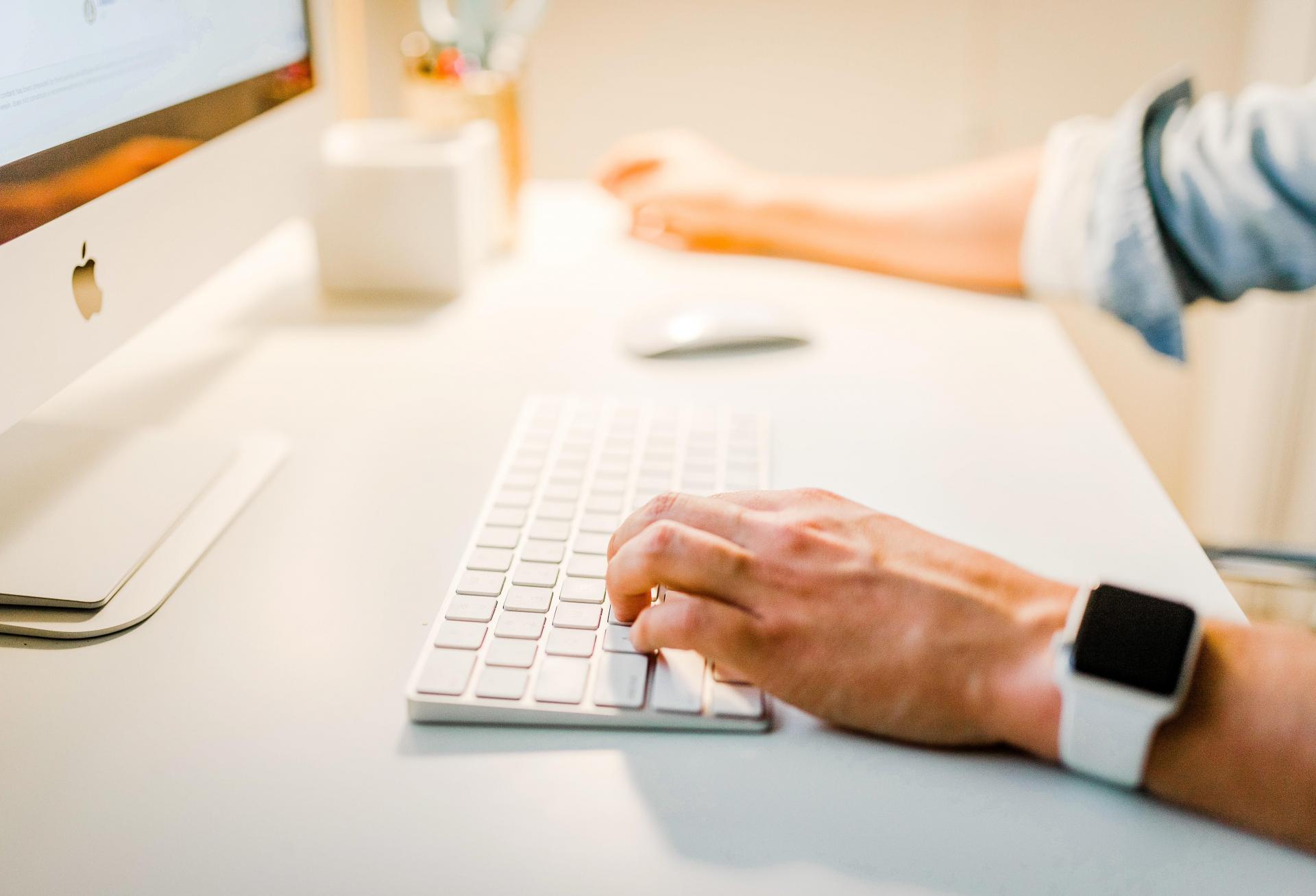 A person sitting at at computer in an office