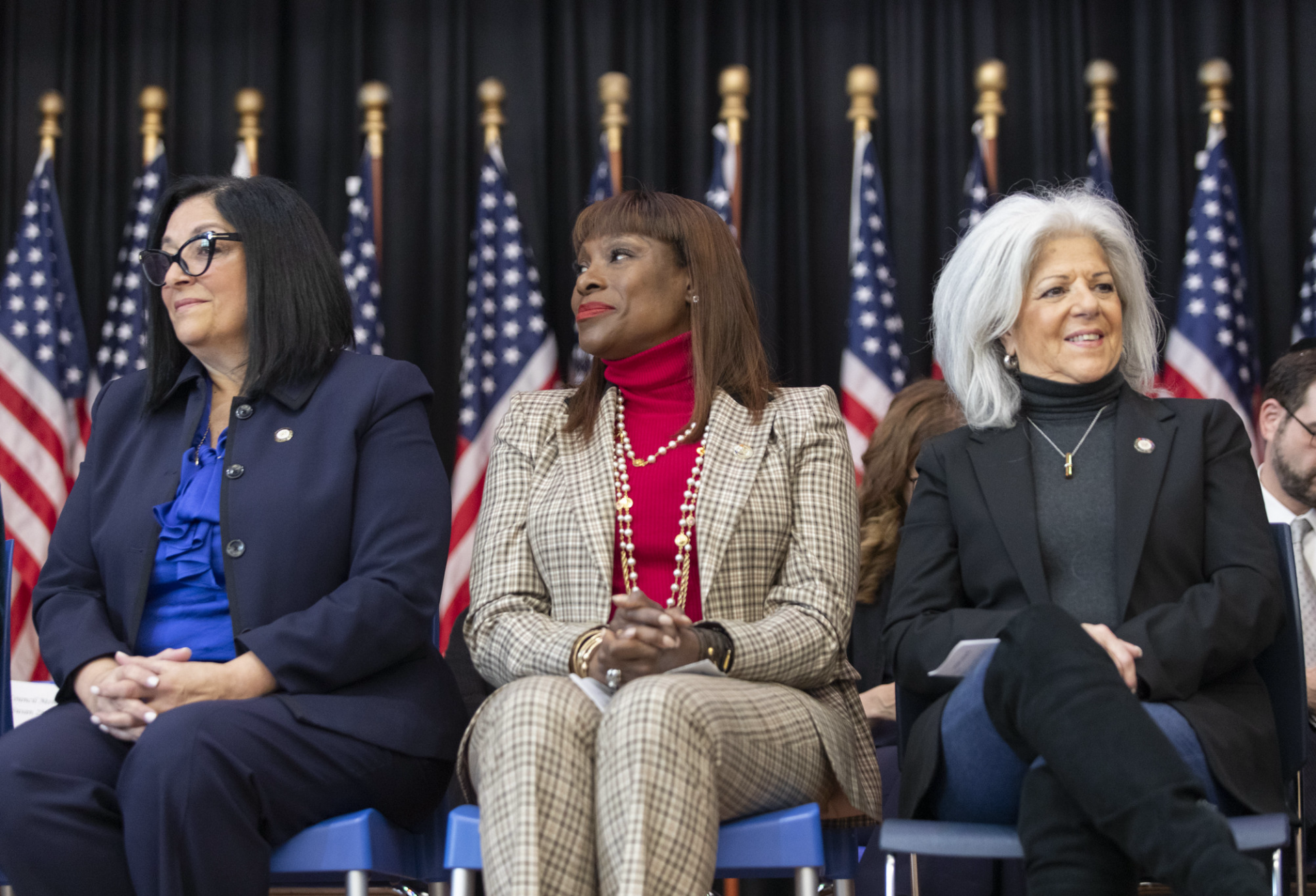 Queens council members Joann Ariola and Vickie Paladino sitting either side of Eric Adams' then aide Ingrid Lewis-Martins at Ariola's 2024 inauguration. 