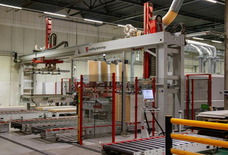 Industrial machinery with robotic arm in a manufacturing facility.