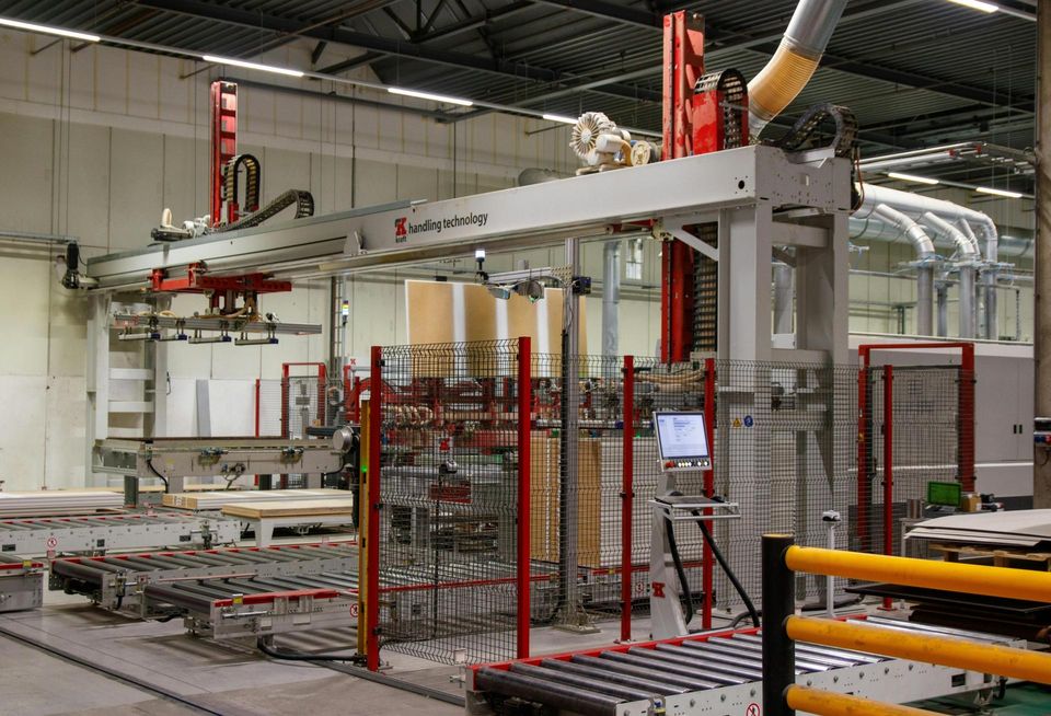 Industrial machinery with robotic arm in a manufacturing facility.