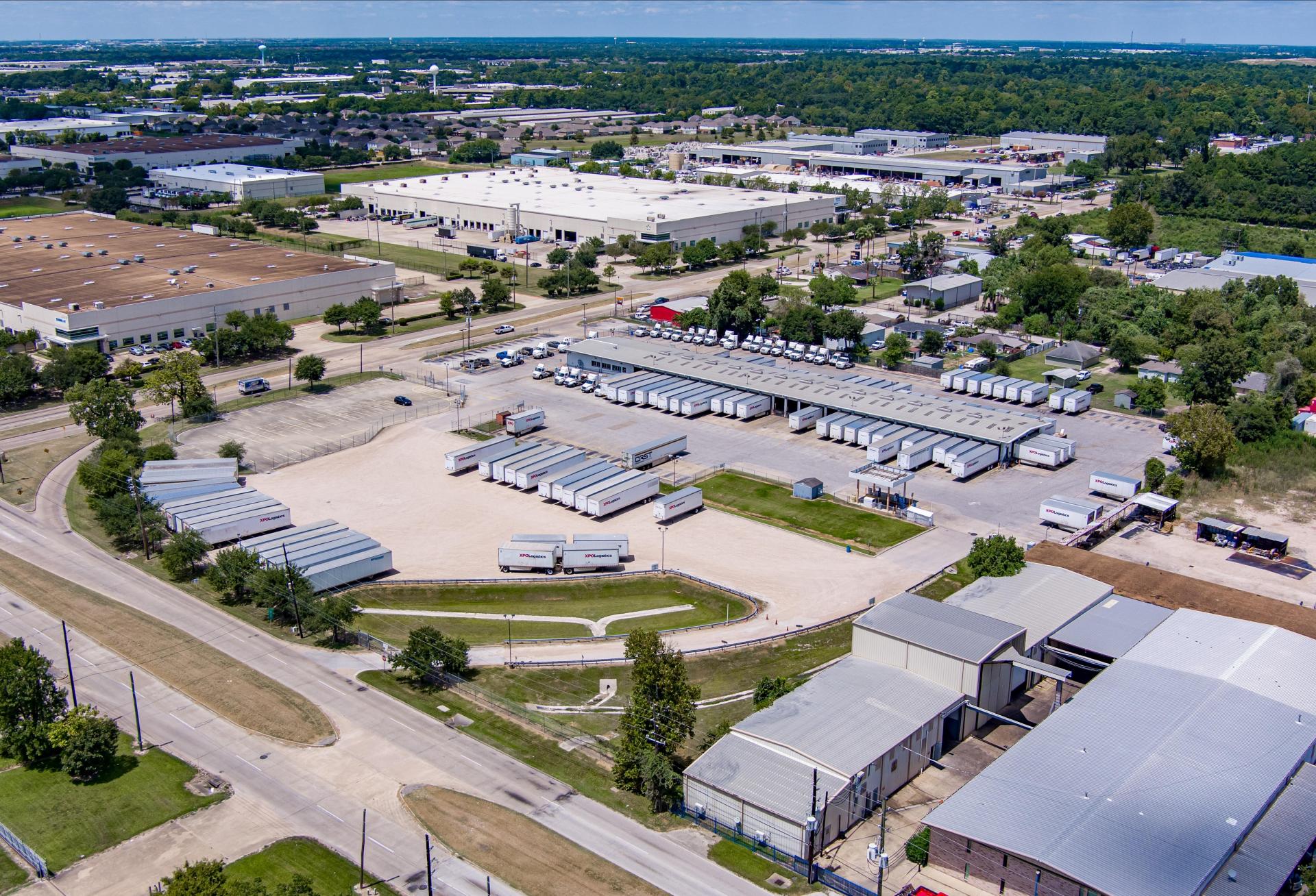Industrial outdoor storage facility with trucks on the lot.
