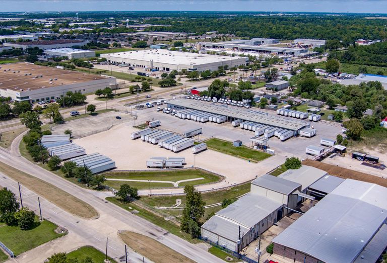 Industrial outdoor storage facility with trucks on the lot.