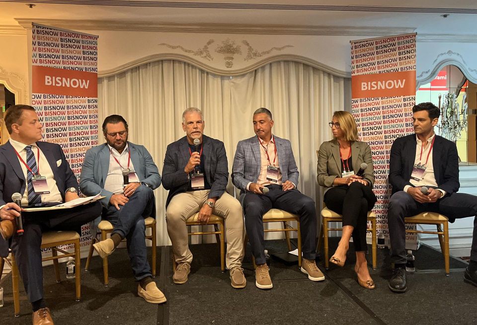 Amato Law Group's Al Amato, G2D Development's Greg DeRosa, BHC Architects' Salvatore Coco, Heatherwood Luxury Rentals' Christopher Capece, Tritec's Kelley Coughlan-Heck and The Beechwood Organization's Steven Dubb on stage at Bisnow's 2023 Long Island State of the Market event.