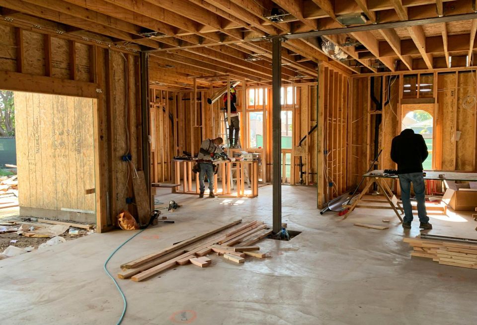 Workers build a house.
