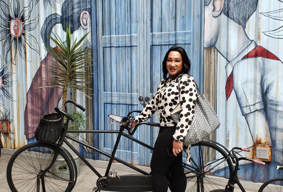 Alexian Advisors managing principal Jennifer Taylor poses in front of a mural at the Westfield Santa Anita mall
