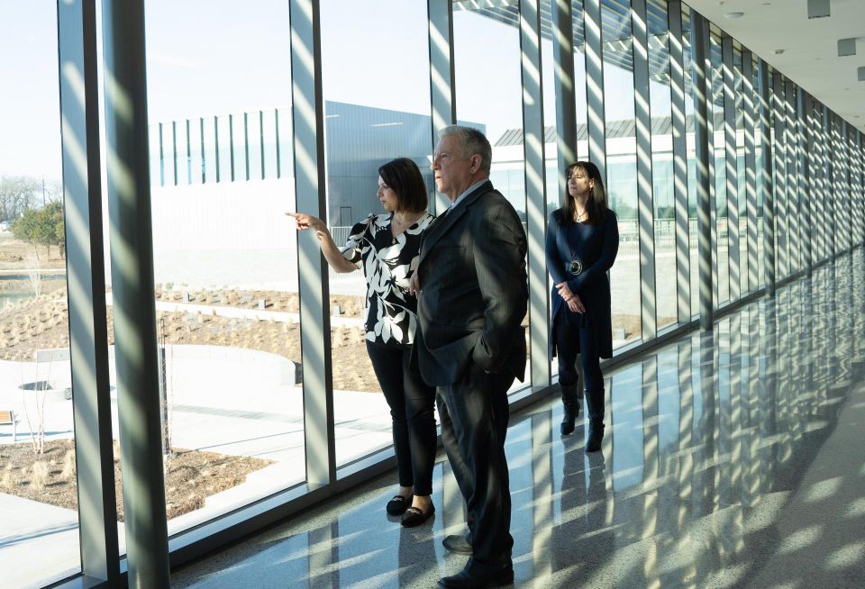 people talking at a window