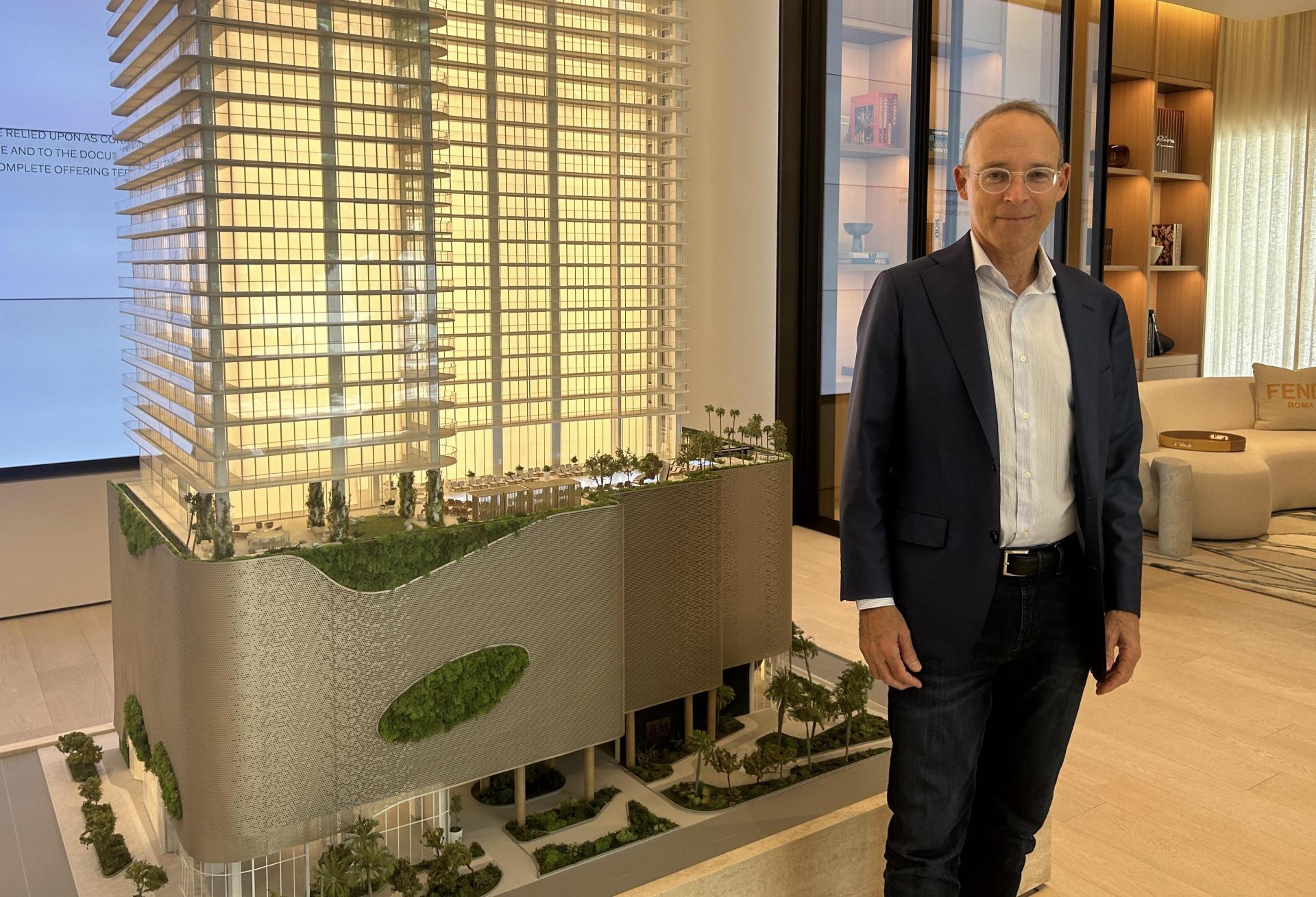 Naftali Group CEO Miki Naftali in front of a model of the JEM Private Residences, his first project in South Florida.