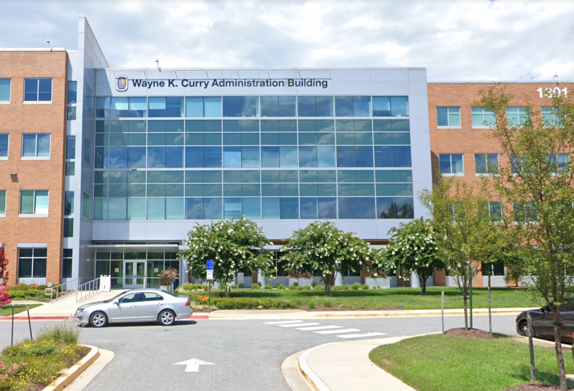 Entrance drive of four-story building labeled 