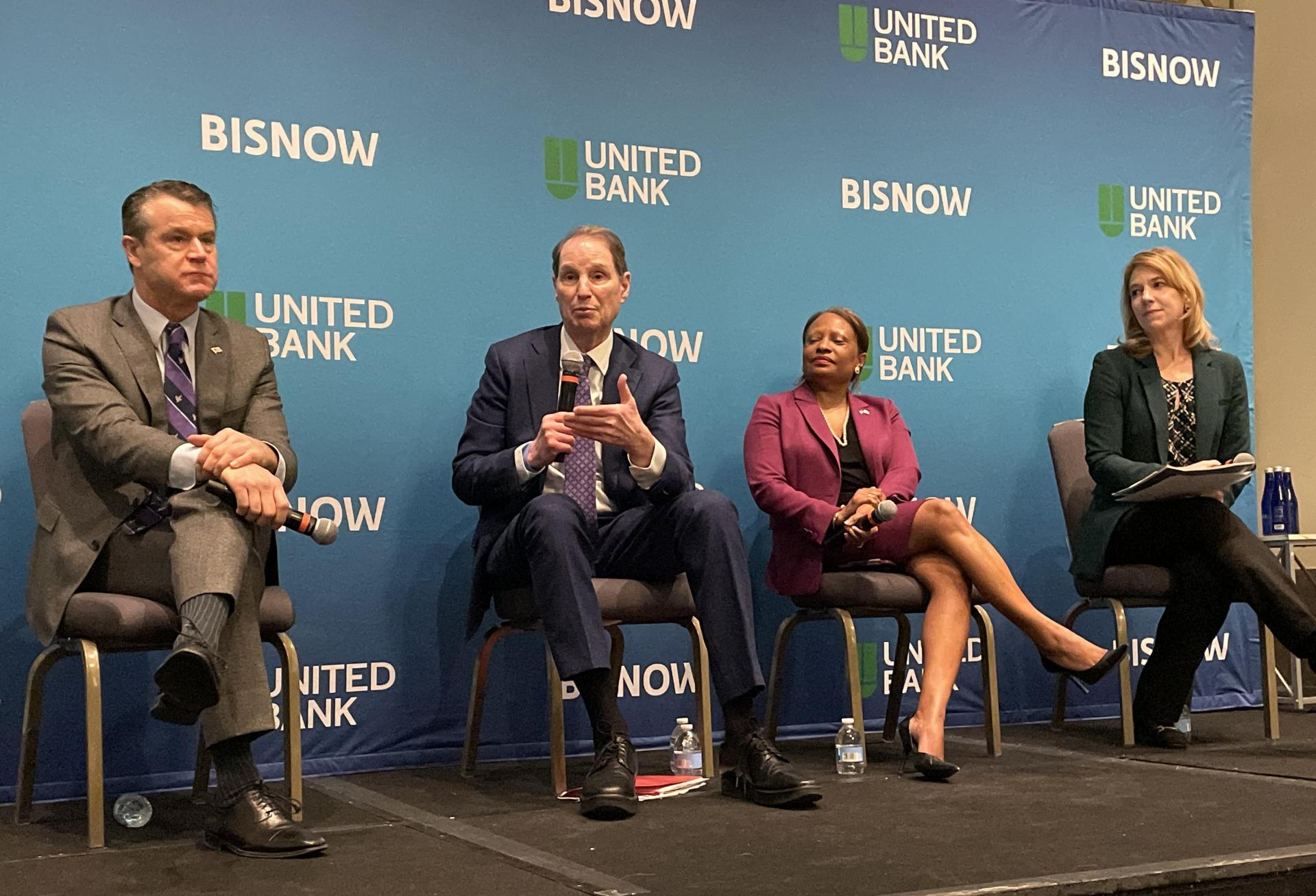 Indiana Sen. Todd Young, Oregon Sen. Ron Wyden, HUD Deputy Secretary Adrianne Todman and NMHC President Sharon Wilson Géno speak at Bisnow's 2023 multifamily conference in Washington.
