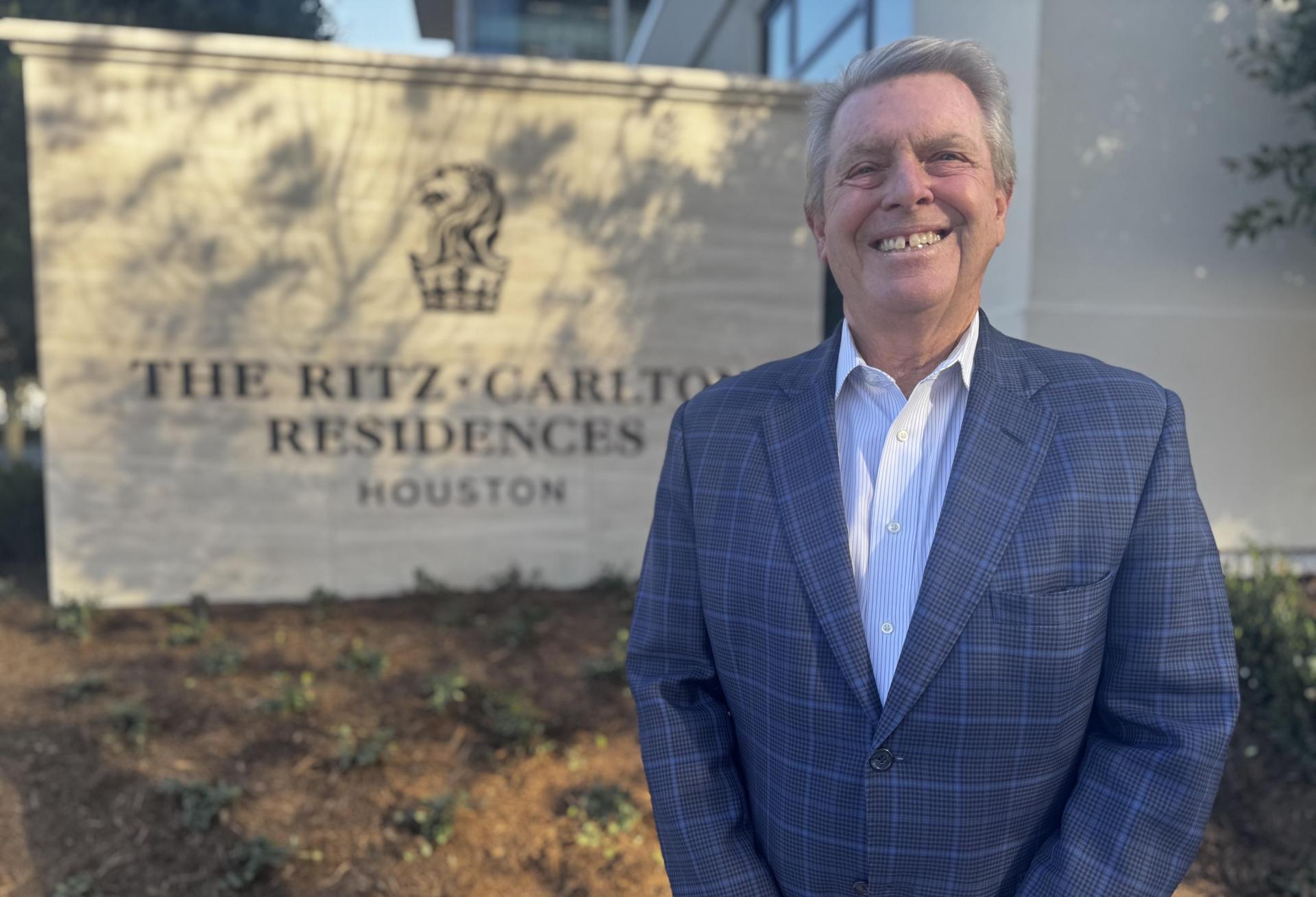 Developer Joe Cleary standing in front of the sign for The Ritz-Carlton Residences Houston.