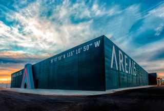 An image of AREA15 with a striking, colorful sky as a backdrop.