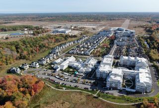 The 1,400-acre South Weymouth Naval Air Station site, with existing residential development in the foreground and future construction sites in the background.