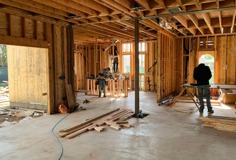 Workers build a house.