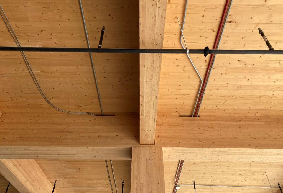 The mass timber columns contain a steel core which helps connect the floors of the addition together and to the original building frame.