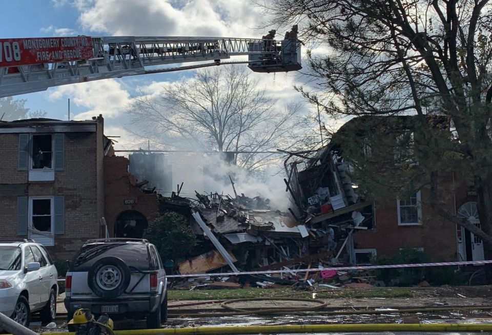 The scene of the fire at Potomac Oaks condominiums in Gaithersburg, Maryland. One building in the center of the photo is substantially collapsed, and the buildings on either side are also heavily damaged.