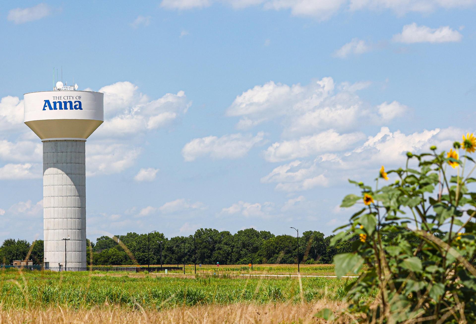 a water tower in a field