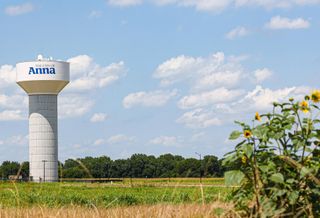 a water tower in a field