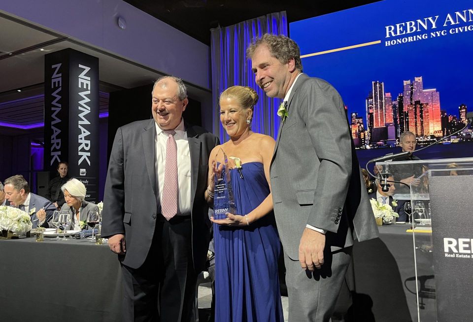 Outgoing REBNY president Jim Whelan onstage at the trade group's 128th gala, presenting an award to JRT Realty Group's Ellen Israel with the help of incoming REBNY president Jed Walentas of Two Trees Management.