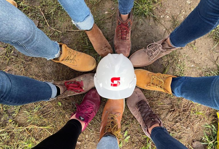 Shoes in a circle around a hardhat
