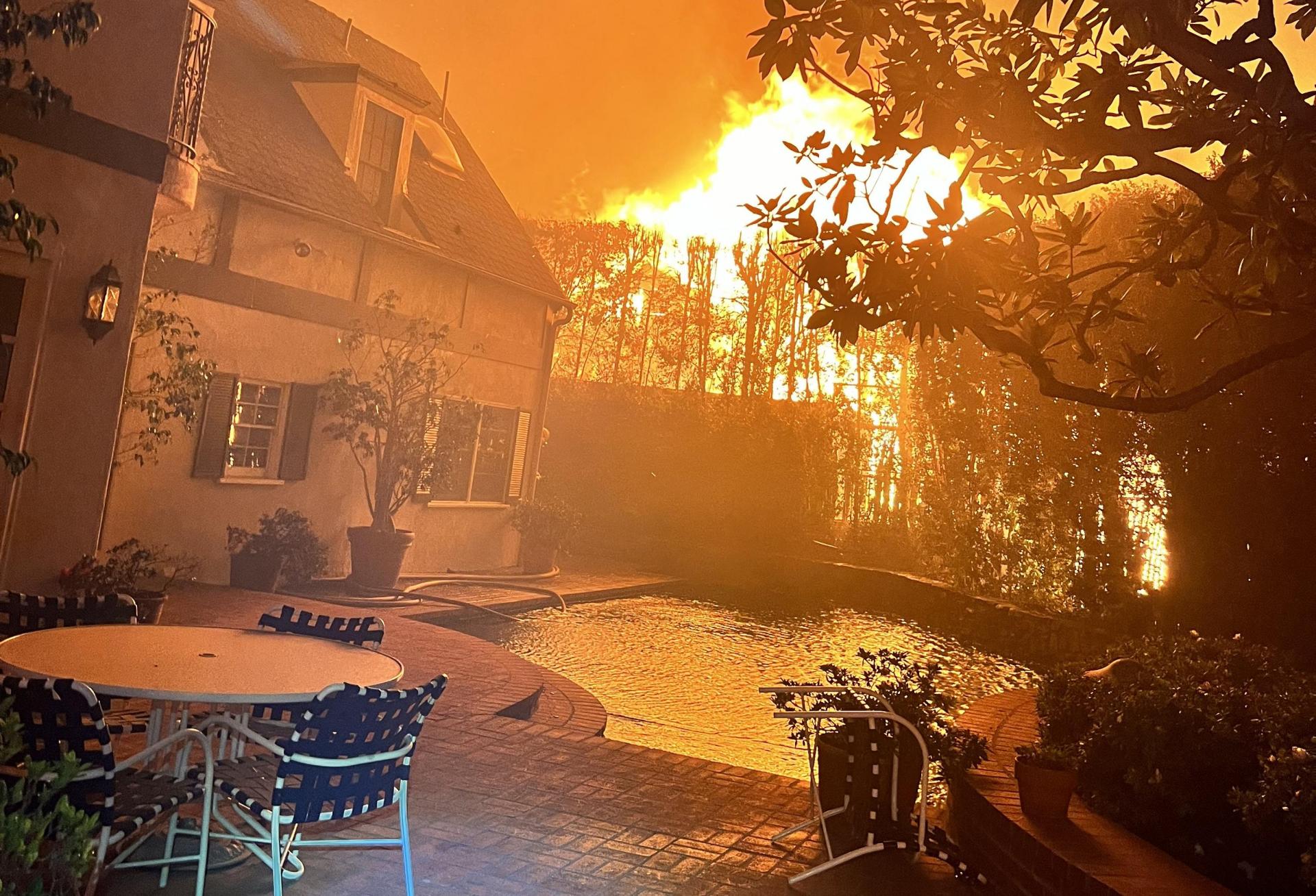 Fire surrounds the only house to survive on a block in The Huntington neighborhood of Los Angeles.