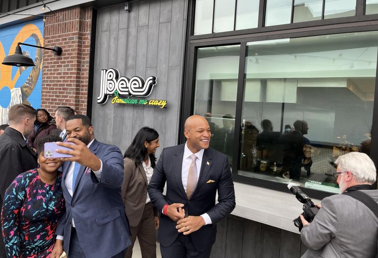 Gov. Wes Moore prepares to ring the bell outside Lexington Market before its ceremonial opening on Tuesday. 