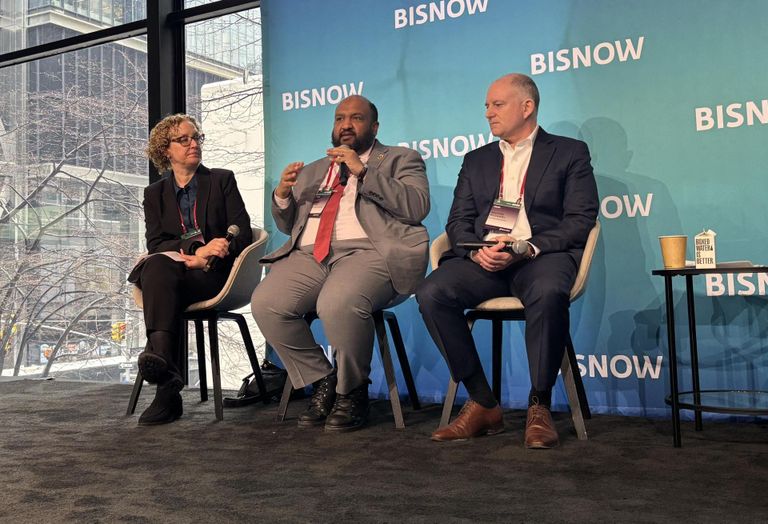 Tannenbaum Helpern's Melissa Billig, NYC DOB Commissioner Ahmed Tigani and STO Building Group's Brooks McDaniel onstage at Bisnow's 2026 New York Conversions and Building Upgrades conference.