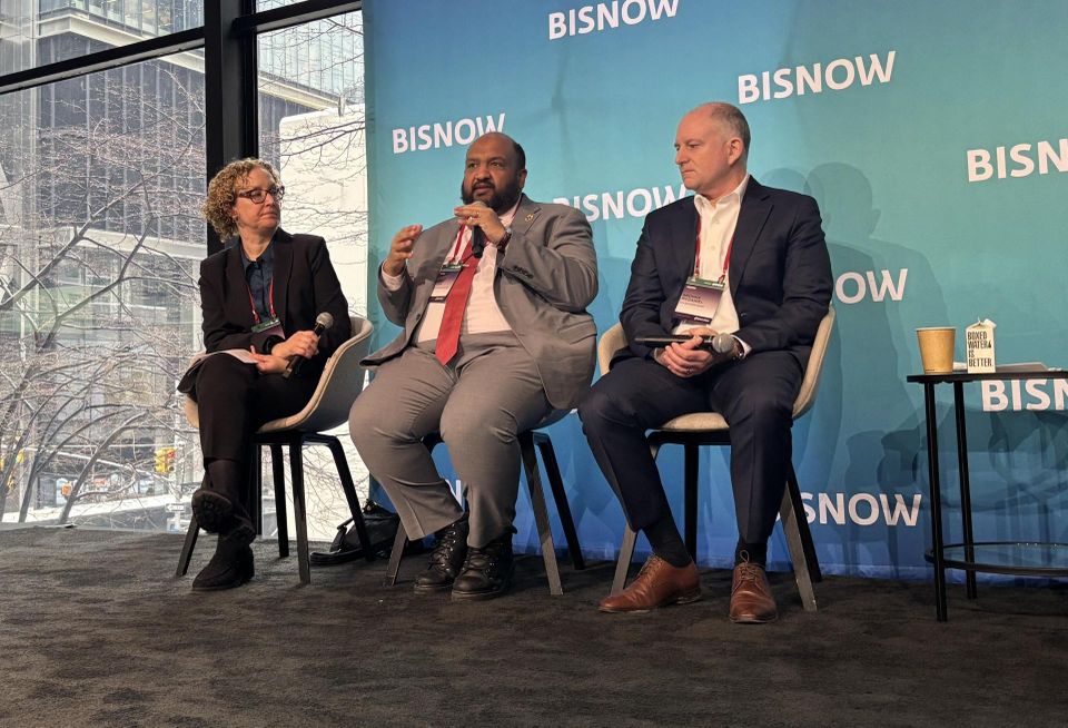 Tannenbaum Helpern's Melissa Billig, NYC DOB Commissioner Ahmed Tigani and STO Building Group's Brooks McDaniel onstage at Bisnow's 2026 New York Conversions and Building Upgrades conference.