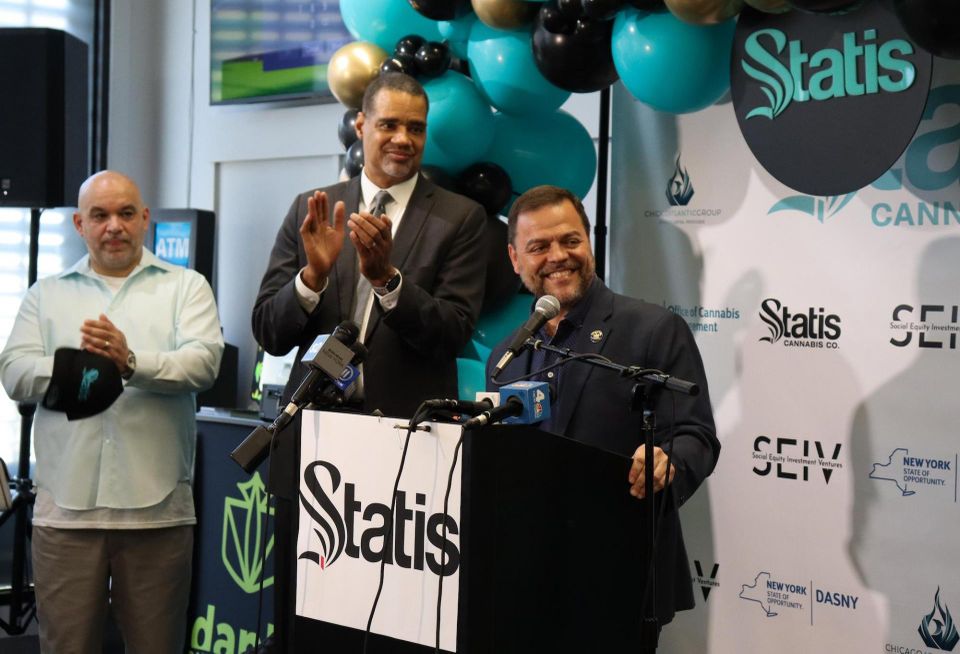 New York state Sen. Luis Sepúlveda speaks at the opening of Statis Cannabis Co. To his left, former CEO of the Dormitory Authority of the State of New York Reuben McDaniel.