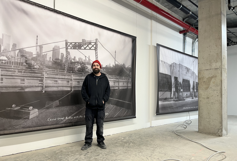Arts Gowanus Executive Director Johnny Thornton installing works by local artists on the ground floor ahead of Union Channel's Jan. 23 opening party.