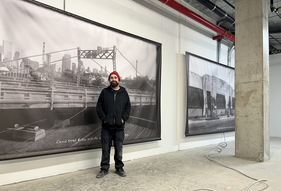 Arts Gowanus Executive Director Johnny Thornton installing works by local artists on the ground floor ahead of Union Channel's Jan. 23 opening party.
