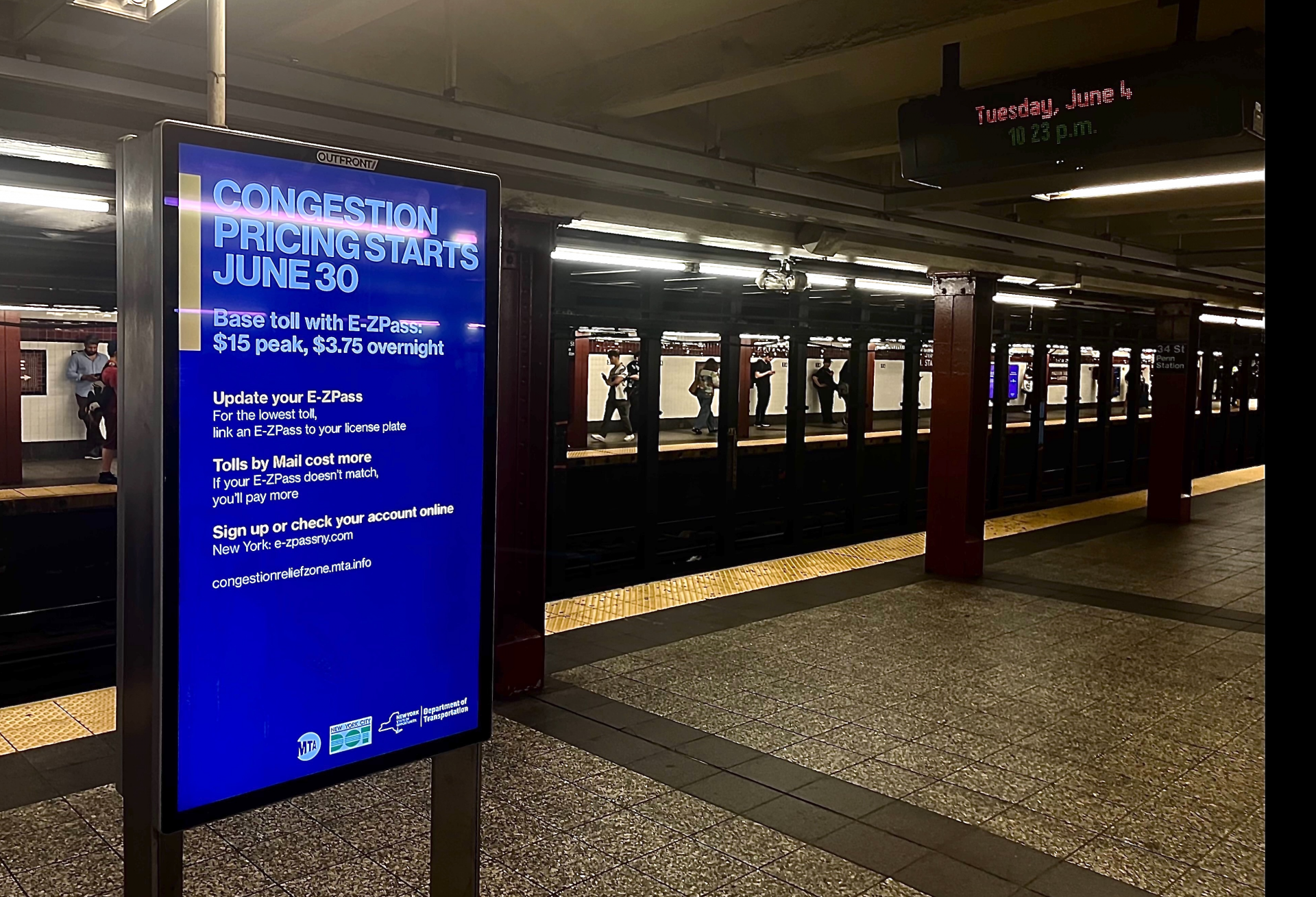 A subway sign promoting congestion pricing