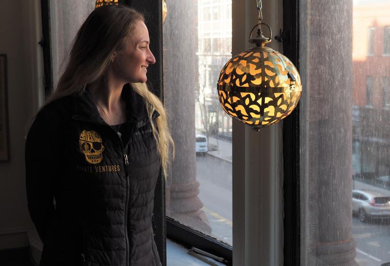 Valero, wearing vest with embroidered Pirate Ventures logo, stares out window