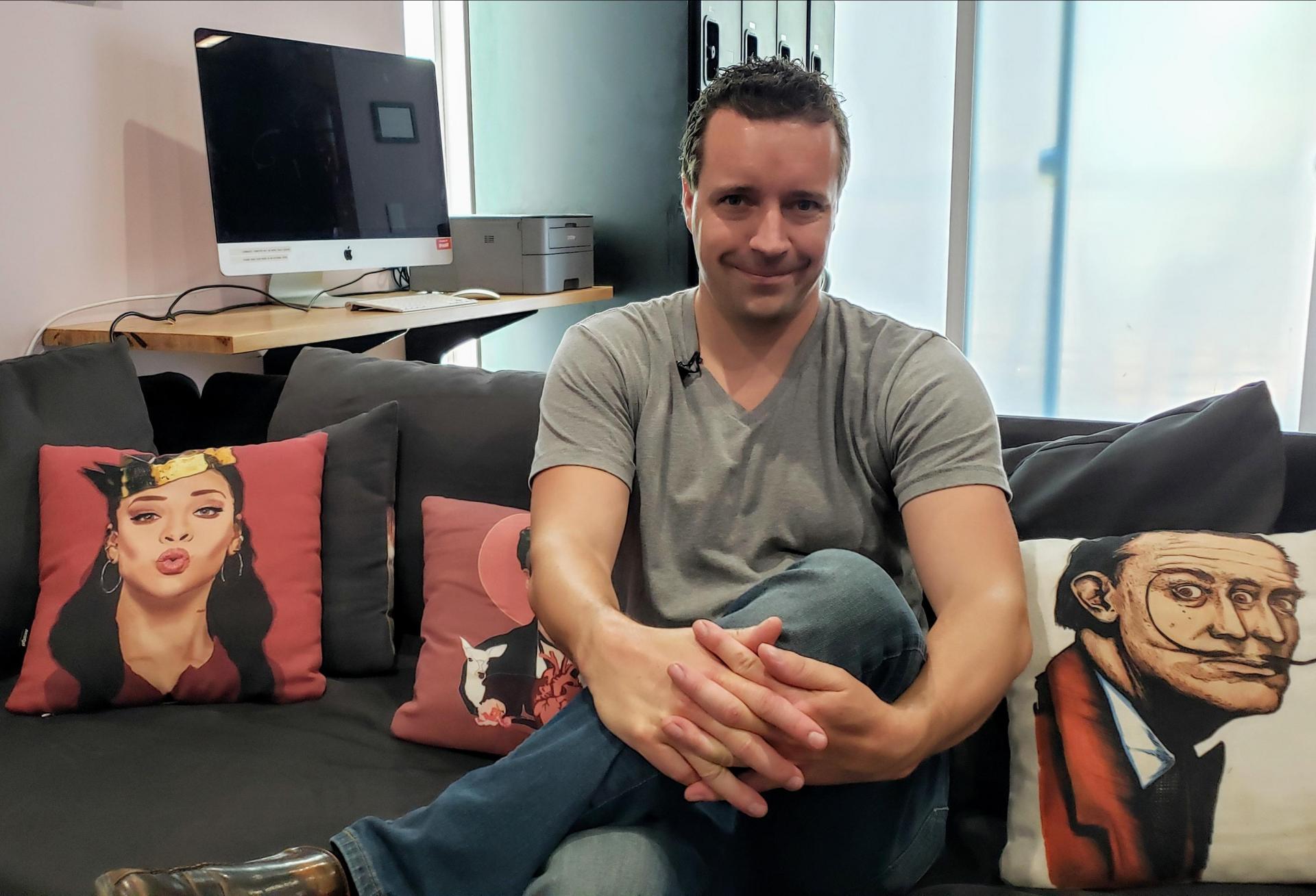 Upstart founder and CEO Jeremiah Adler sits down on a couch at one of his co-living buildings, the Hobart House, in Los Angeles