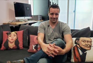 Upstart founder and CEO Jeremiah Adler sits down on a couch at one of his co-living buildings, the Hobart House, in Los Angeles
