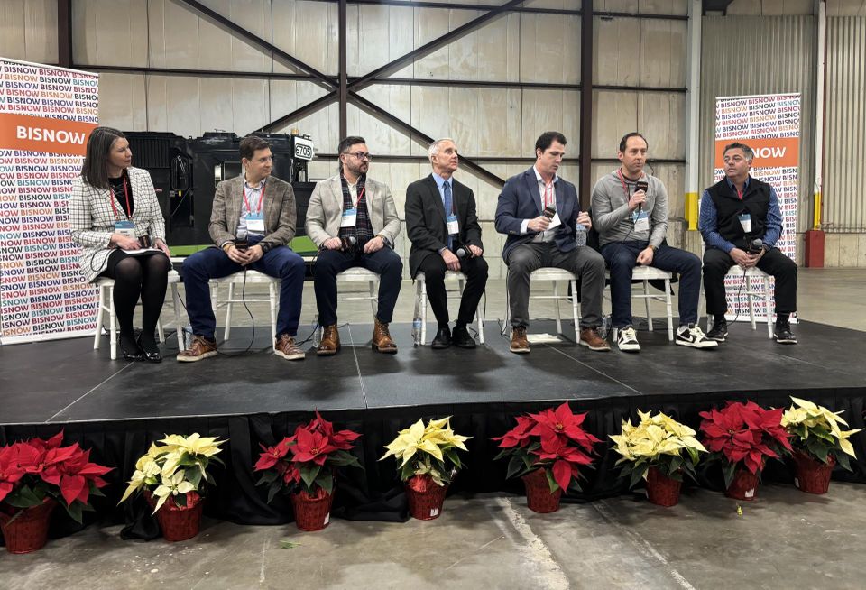 Sitting on a stage, from left to right: Landmarks Illinois' Bonnie McDonald, WindWave's Jonathan Cordell, Epstein's Patrick Carata, BTL Architects' Delph Gustitus, Concord Capital's Drew Millard, Mavrek's Anthony Hrusovsky and McHugh Construction's Ray Cisco.