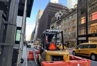 A construction vehicle in front of the LVMH tower, a block away from Related's 625 Madison Ave.